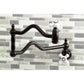 Kingston Brass KS2107PX Heritage Wall Mount Pot Filler Faucet, Brushed Brass on stylish backsplash.