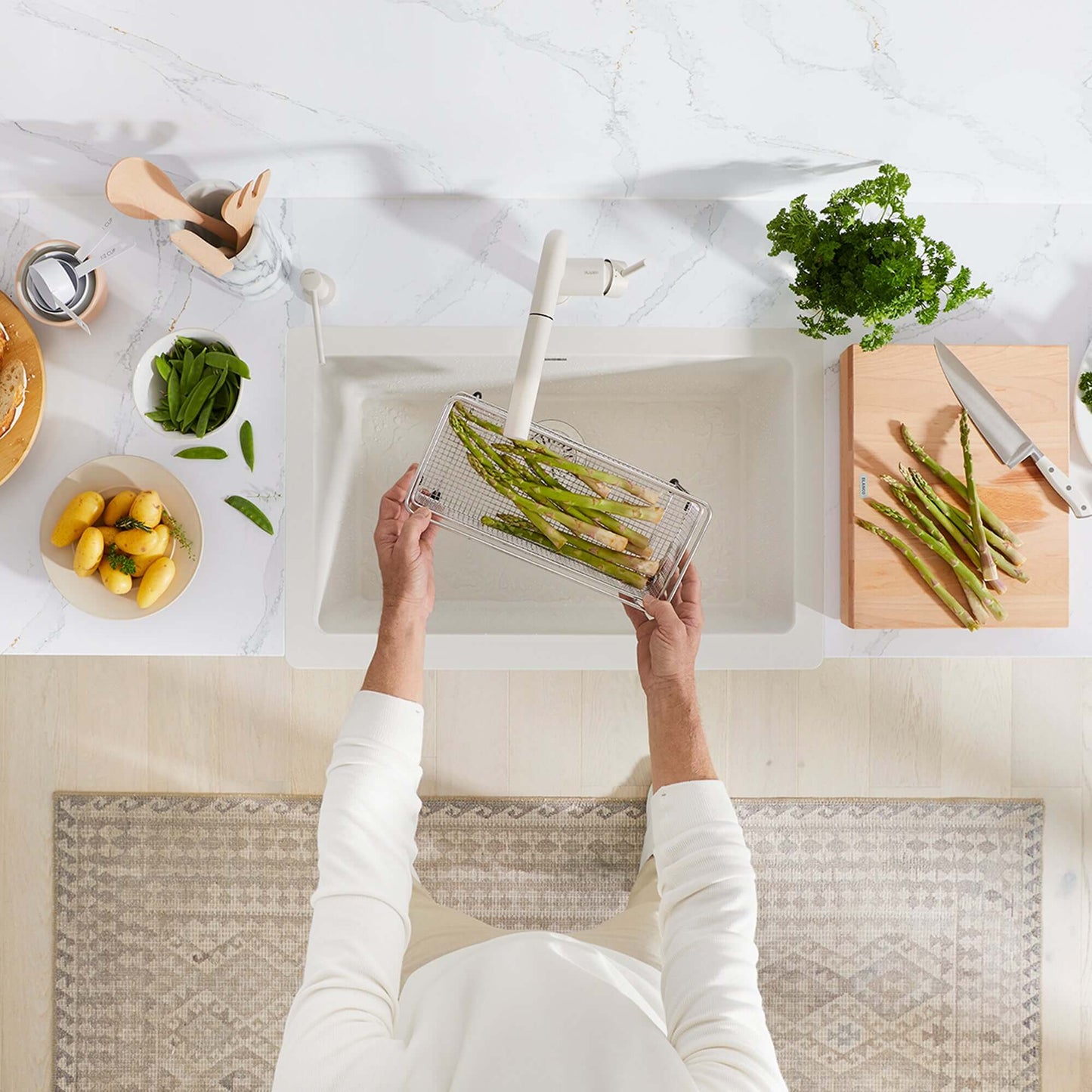 BLANCO VINTERA 30" SILGRANIT Single Bowl Farmhouse Sink with fresh asparagus being rinsed and prepared in a modern kitchen.