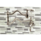 Kingston Brass KS2107TAL Tudor Wall Mount Pot Filler Faucet, Brushed Brass against modern tile backsplash.