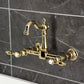 Kingston KS2443TAL Tudor Two-Handle Wall Mount Bridge Kitchen Faucet, Antique Brass in a luxurious design against a marble backdrop.