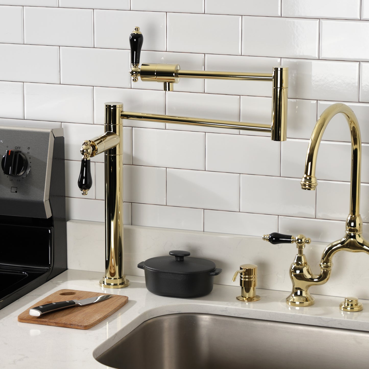 Kingston Brass KS4707PKL Duchess Deck Mount Pot Filler Faucet, Brushed Brass with black porcelain handles in kitchen.