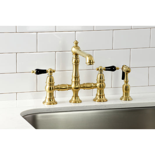 Kingston KS7277PKLBS Duchess Bridge Kitchen Faucet with Brass Sprayer, Brushed Brass on a kitchen counter