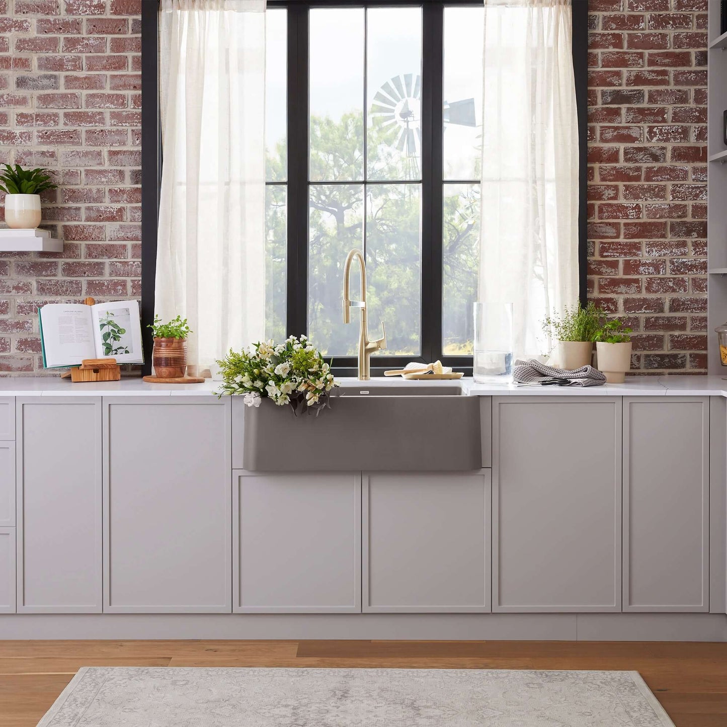 BLANCO Ikon SILGRANIT 33" Single Bowl Apron-Front Farmhouse Sink in modern kitchen with natural light.