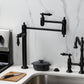 Kingston Brass KS3707PKL Duchess Deck Mount Pot Filler Faucet, Brushed Brass with black porcelain handles in kitchen.