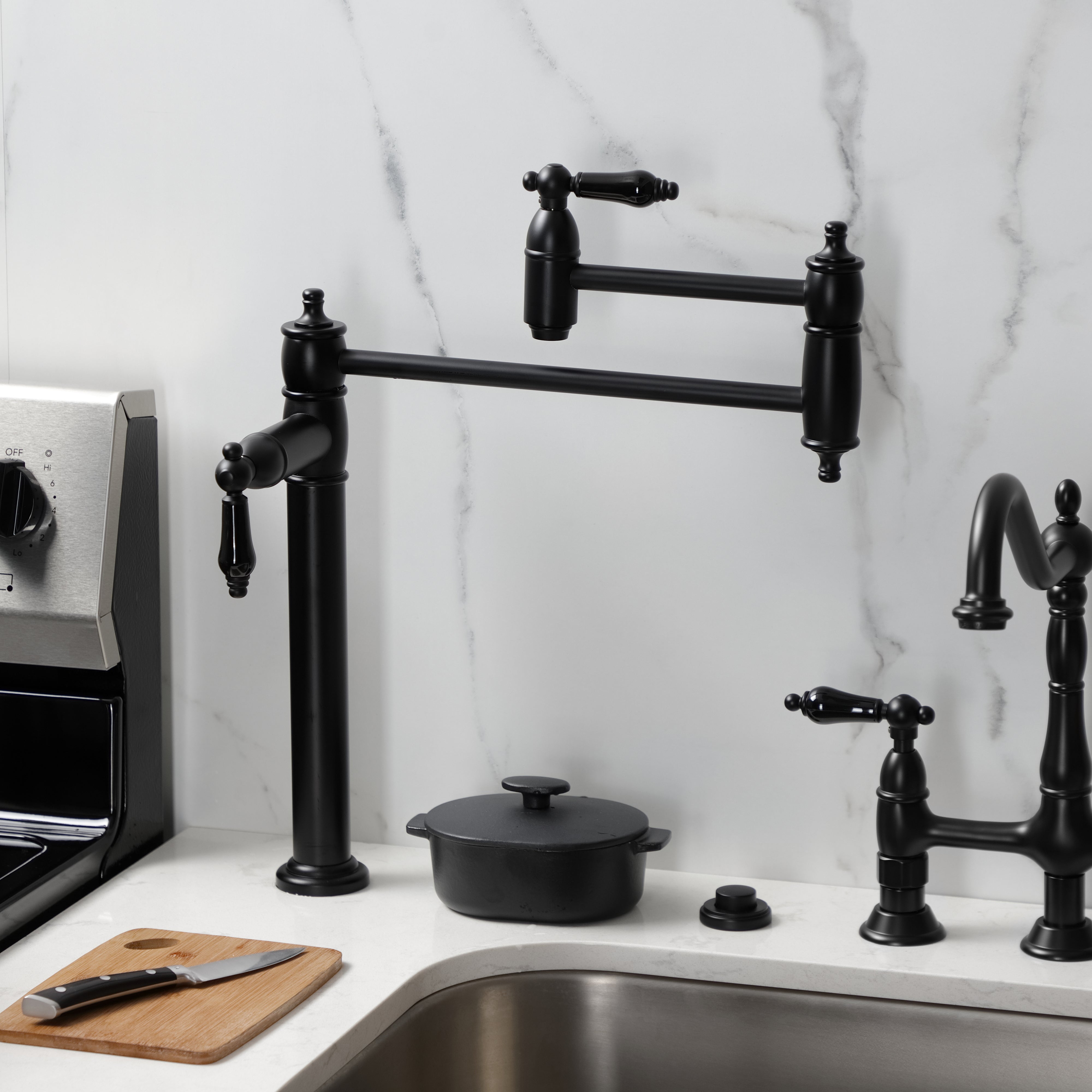 Kingston Brass KS3707PKL Duchess Deck Mount Pot Filler Faucet, Brushed Brass with black porcelain handles in kitchen.