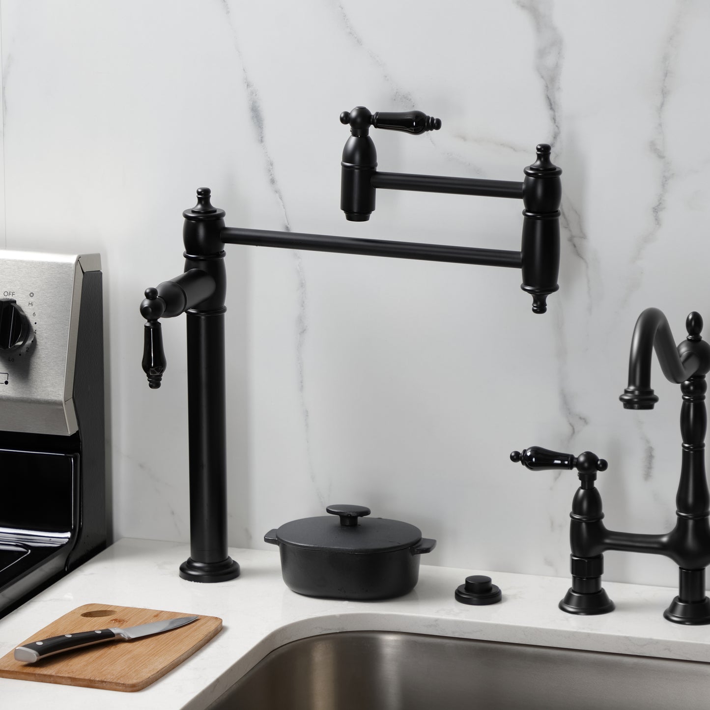 Kingston Brass KS3707PKL Duchess Deck Mount Pot Filler Faucet, Brushed Brass with black porcelain handles in kitchen.
