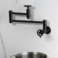Kingston Brass KS8103CG Fuller Wall Mount Pot Filler Faucet, Antique Brass against a marble backdrop.