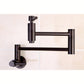 Kingston Brass KS8103DL Concord Wall Mount Pot Filler Faucet, Antique Brass on a tiled wall.