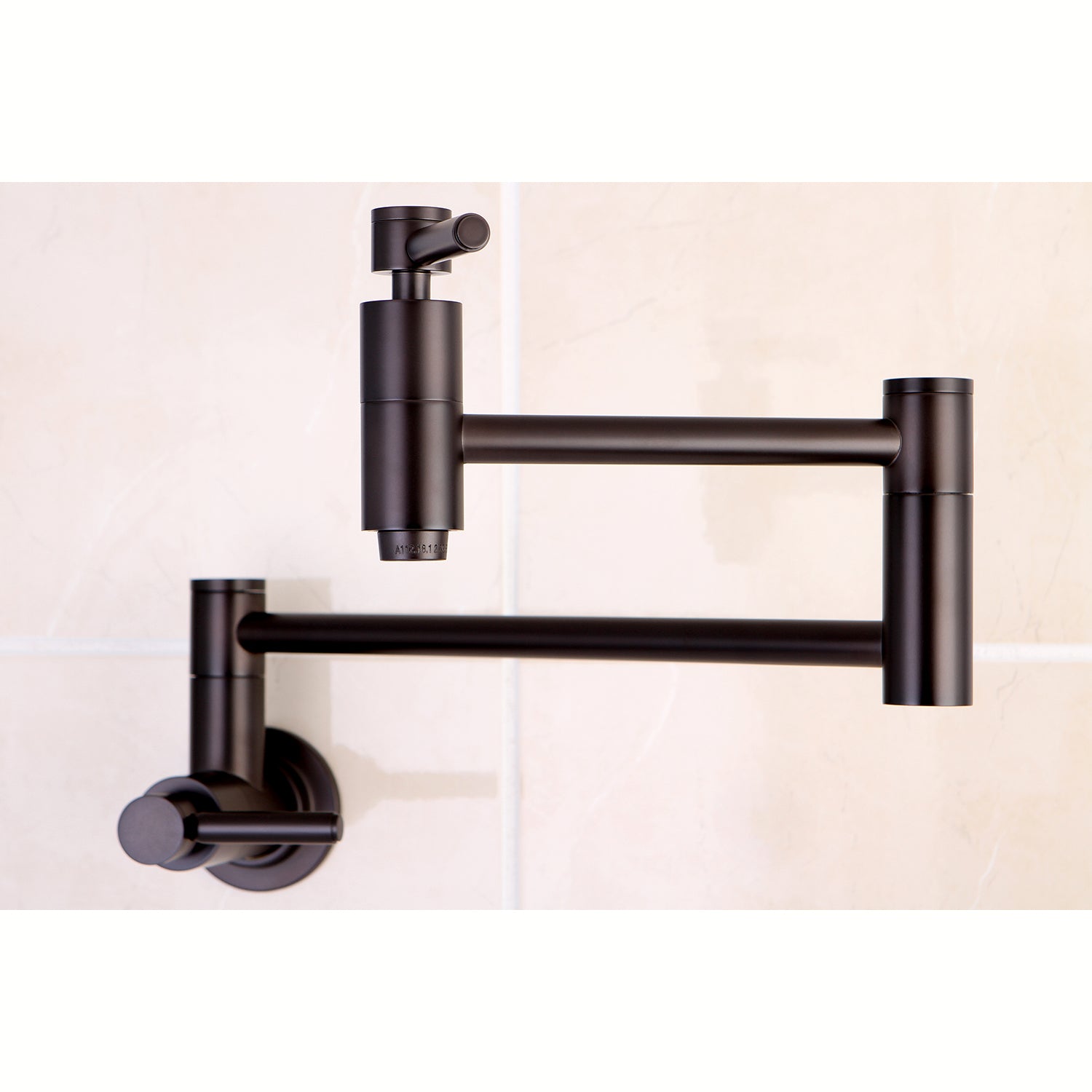 Kingston Brass KS8103DL Concord Wall Mount Pot Filler Faucet, Antique Brass on a tiled wall.