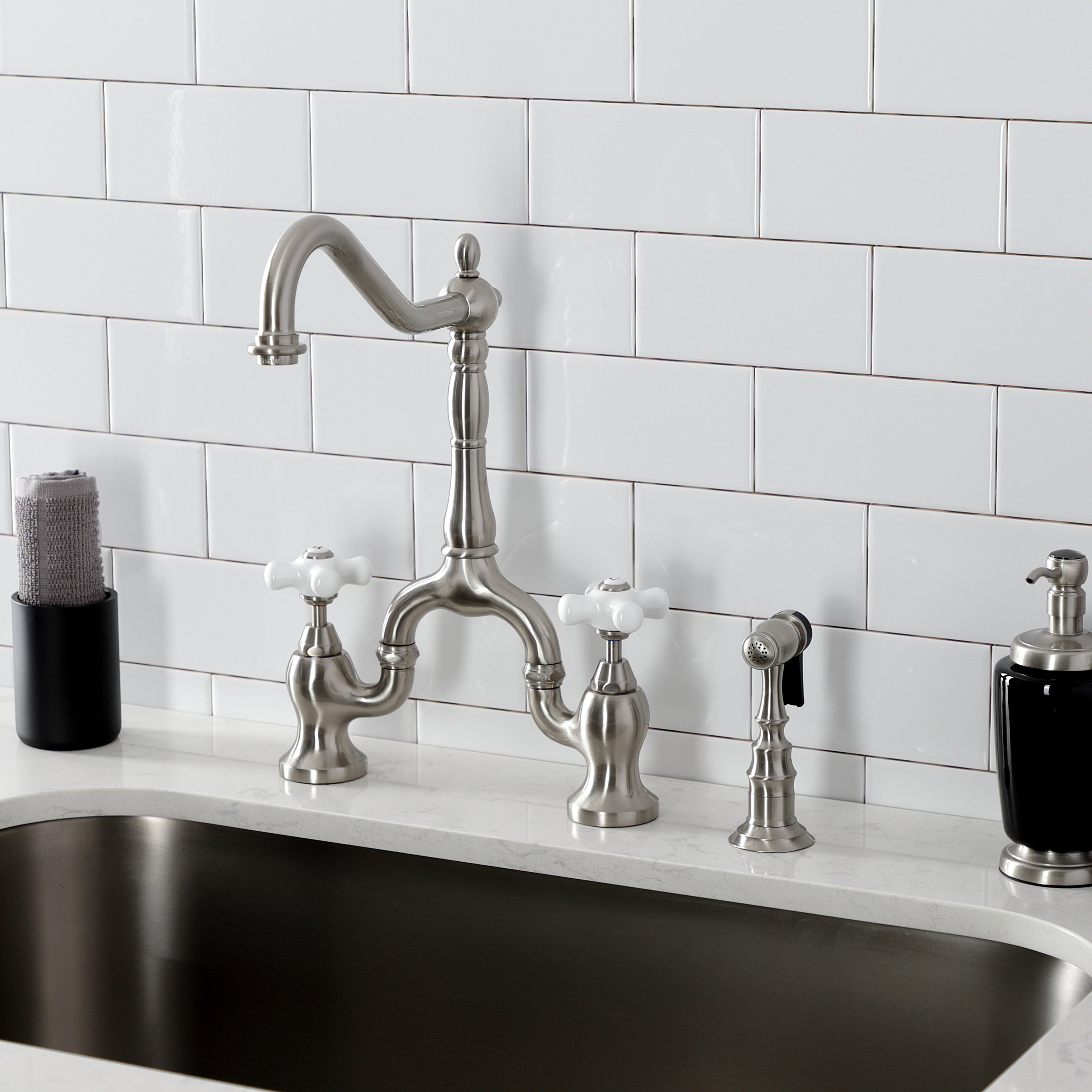 Kingston KS7758PXBS English Country Bridge Kitchen Faucet with Brass Sprayer, Brushed Nickel on a countertop.