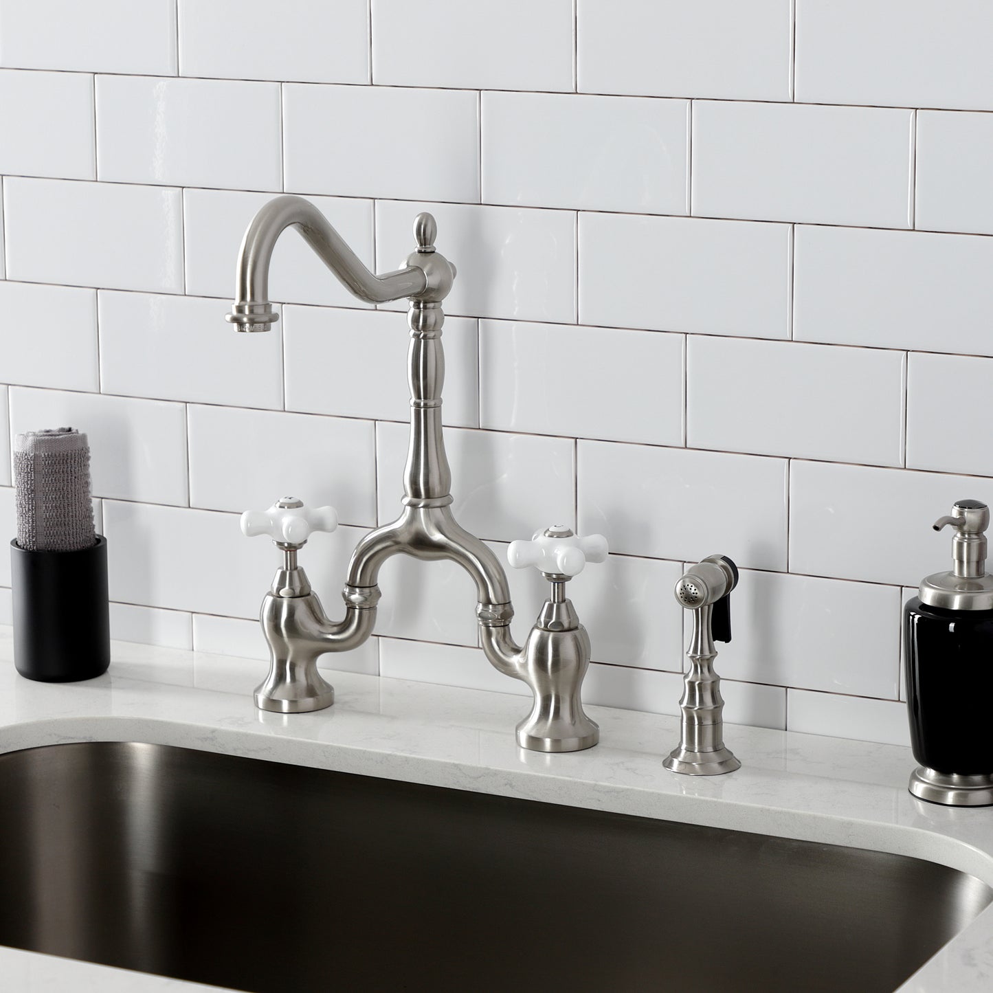 Kingston KS7758PXBS English Country Bridge Kitchen Faucet with Brass Sprayer, Brushed Nickel on a countertop.