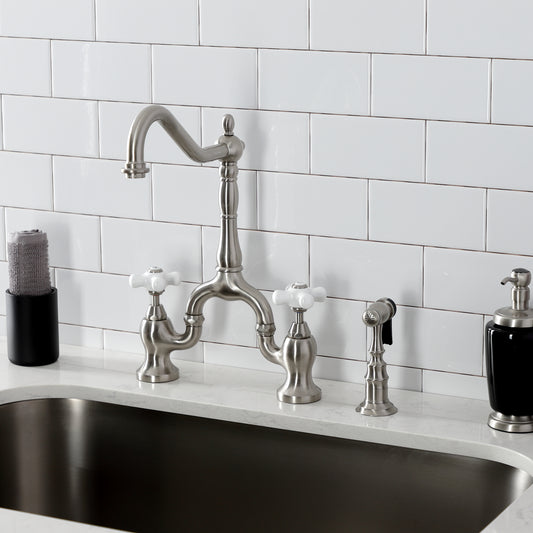 Kingston KS7758PXBS English Country Bridge Kitchen Faucet with Brass Sprayer, Brushed Nickel on a countertop.