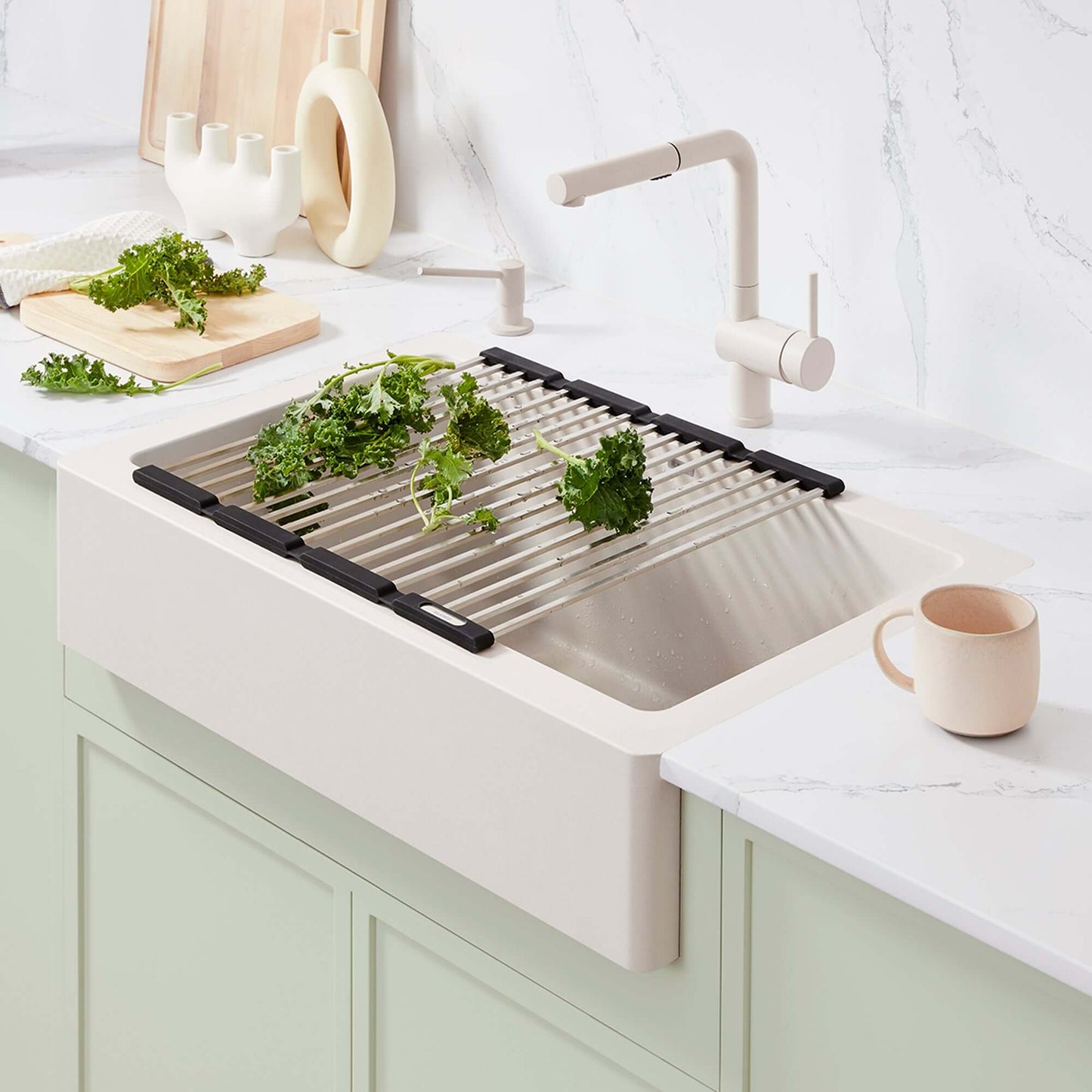 BLANCO Linus Low Arc Pull-Out Dual-Spray Kitchen Faucet - Soft White with fresh greens in a modern kitchen sink.