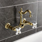 Kingston KS2443PX Heritage Two-Handle Wall Mount Bridge Kitchen Faucet, Antique Brass in a classic setting.