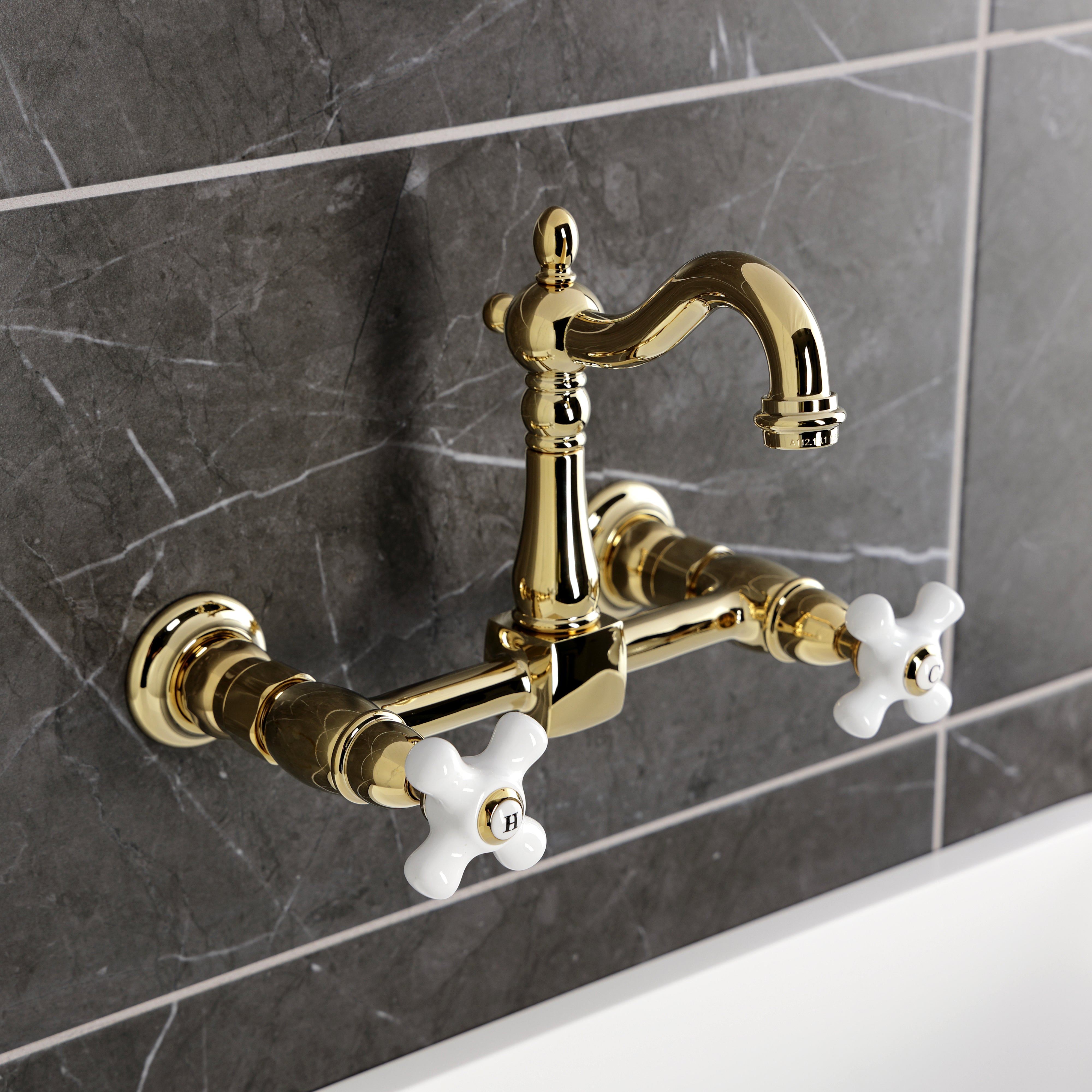 Kingston KS2443PX Heritage Two-Handle Wall Mount Bridge Kitchen Faucet, Antique Brass in a classic setting.