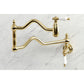 Kingston Brass KS2107PL Heritage Wall Mount Pot Filler Faucet, Brushed Brass on marble background.