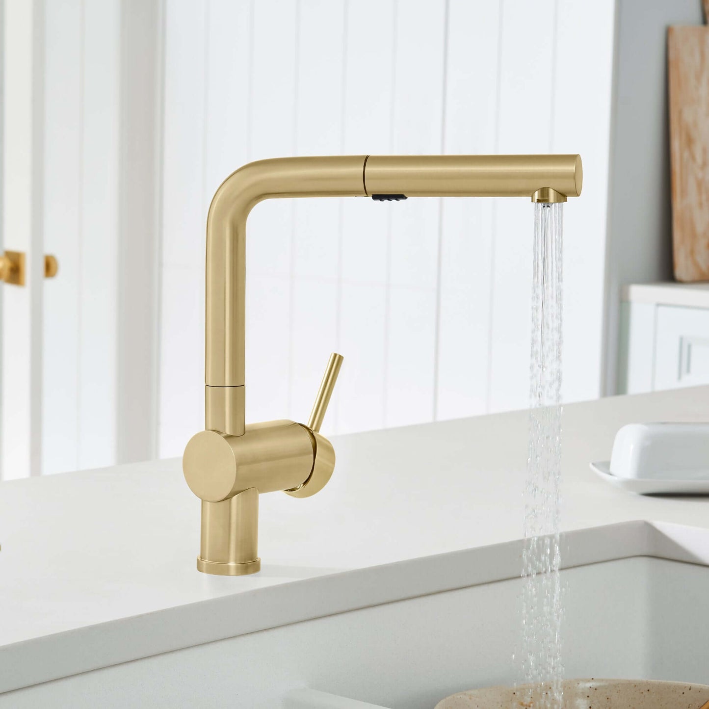 BLANCO Linus Low Arc Pull-Out Dual-Spray Kitchen Faucet - Gold finish in stylish kitchen setting.