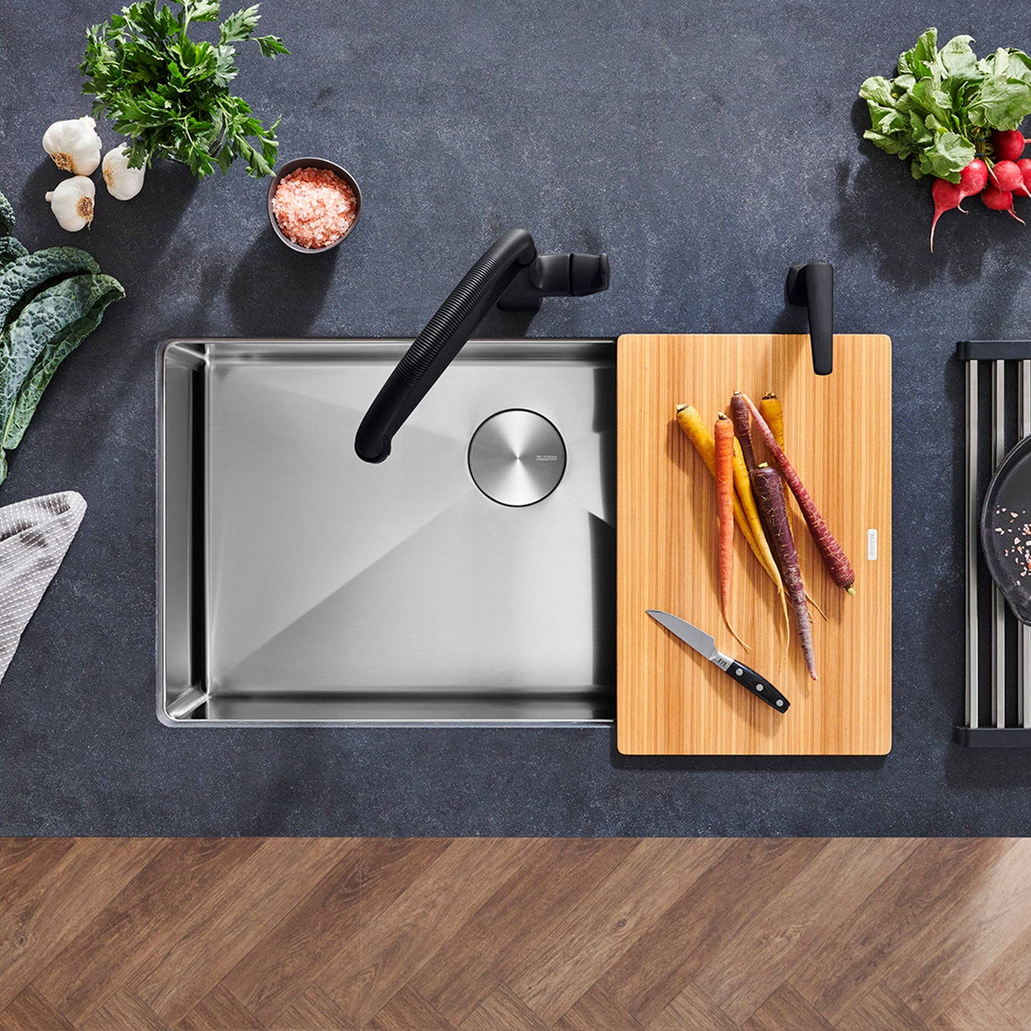 BLANCO Quatrus R15 32" Super Single Bowl Undermount Stainless Steel Kitchen Sink with cutting board and fresh vegetables.