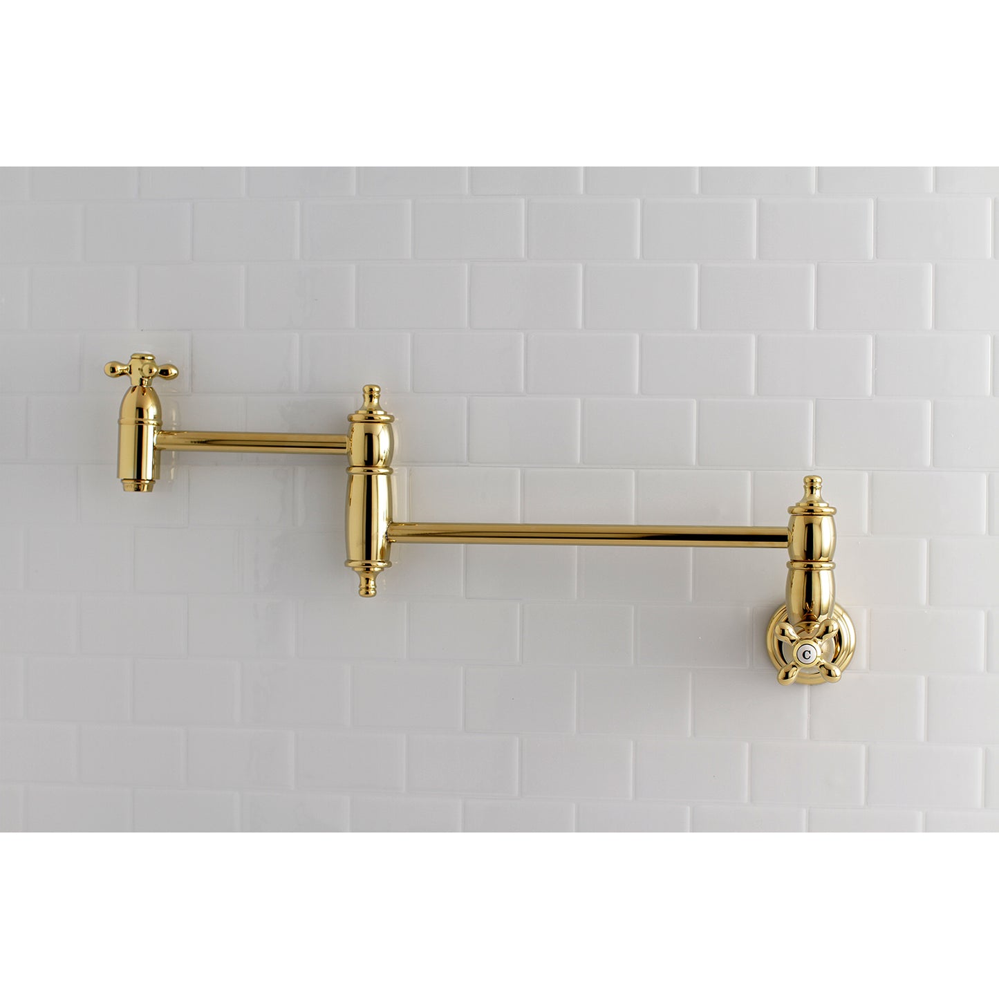 Kingston Brass KS3103AX Restoration Wall Mount Pot Filler Faucet, Antique Brass against white tiled wall.