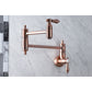Kingston Brass KS3103BAL Heirloom Wall Mount Pot Filler Faucet, Antique Brass close-up on marble background