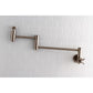 Kingston Brass KS8103ZX Millennium Wall Mount Pot Filler Faucet, Antique Brass mounted on wall