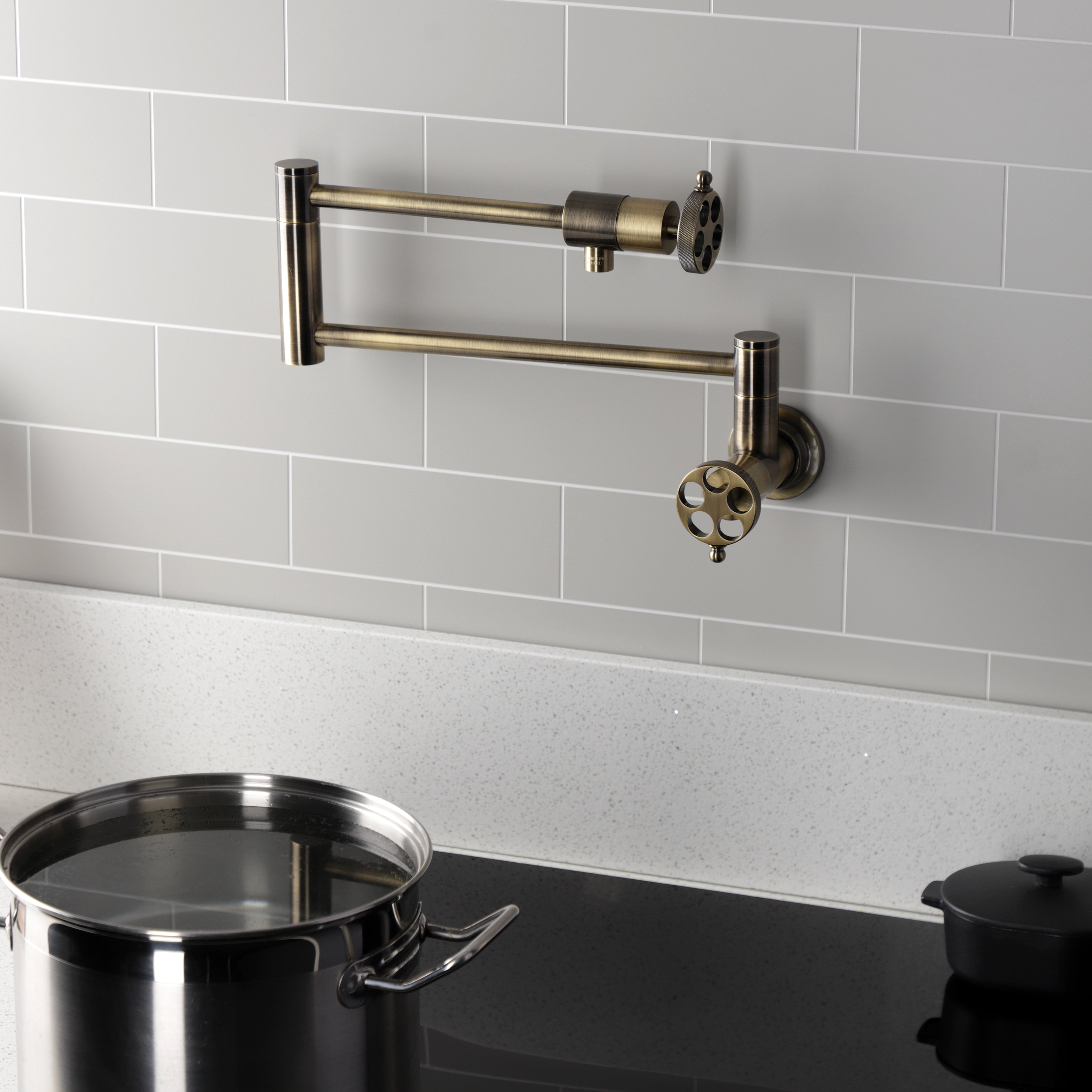 Kingston Brass KS4103RKZ Wendell Wall Mount Pot Filler Faucet with Knurled Handle, Antique Brass in kitchen setting