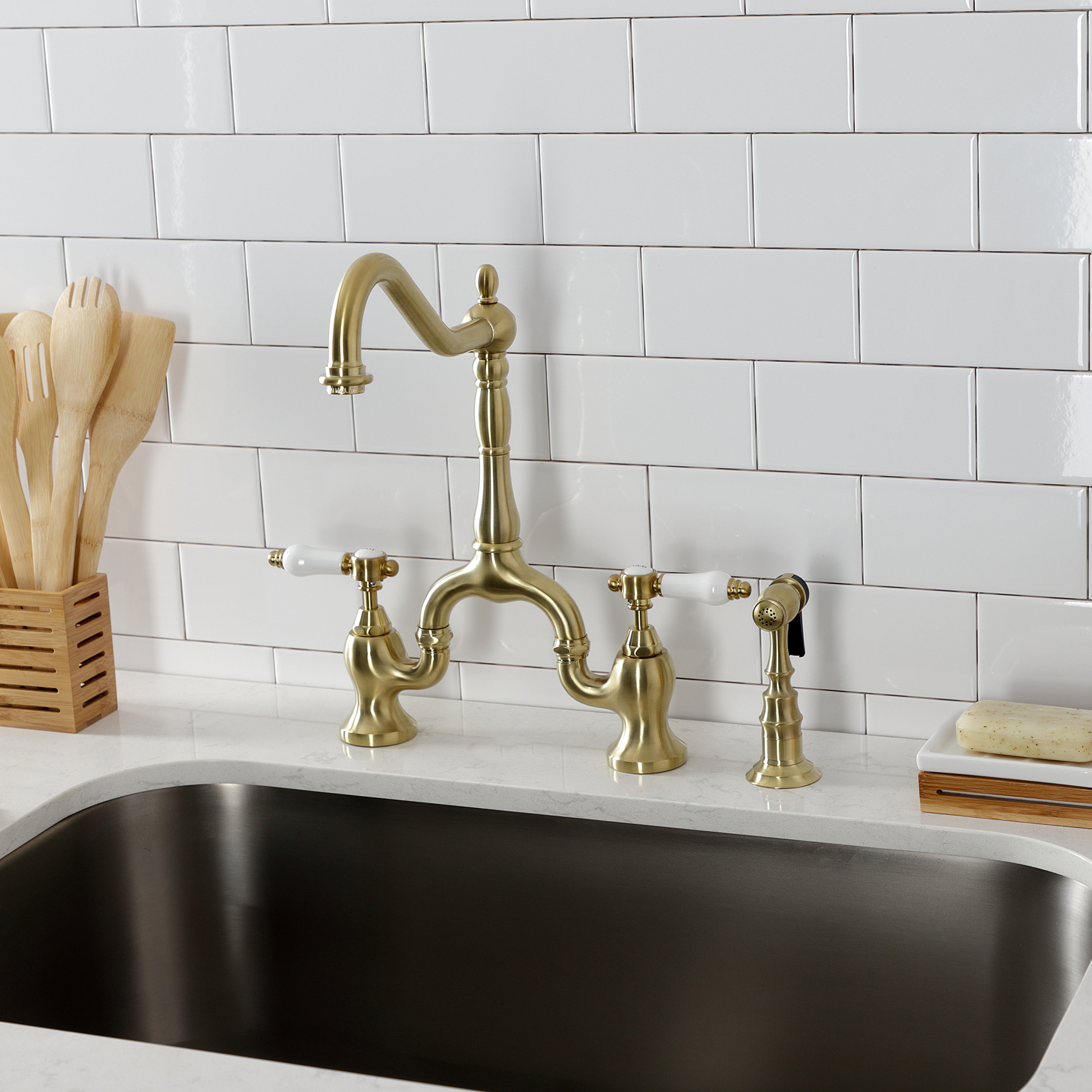 Kingston KS7753BPLBS Bel-Air Bridge Kitchen Faucet with Brass Sprayer, Antique Brass in a modern kitchen setting