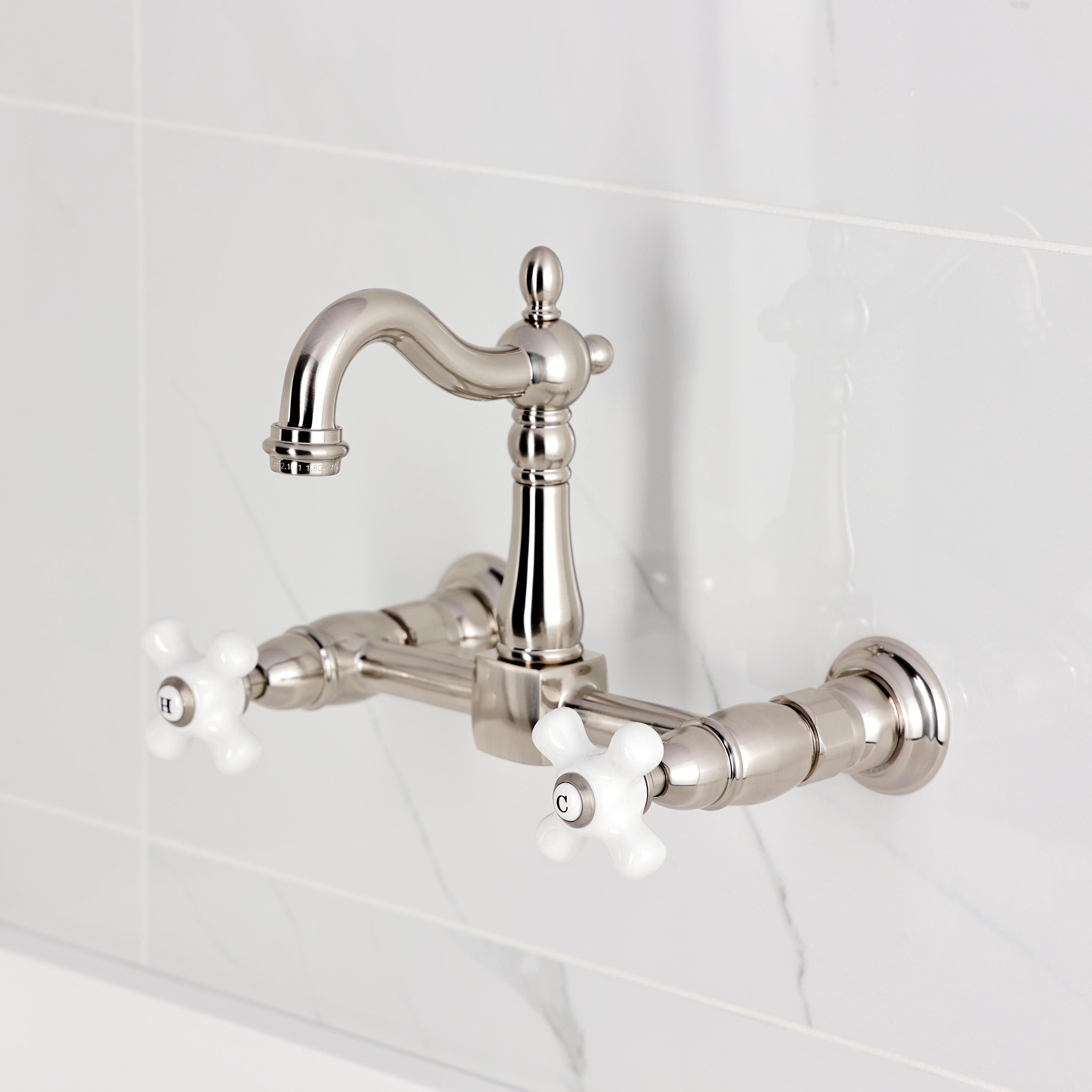 Kingston KS2443PX Heritage Two-Handle Wall Mount Bridge Kitchen Faucet, Antique Brass with white porcelain cross handles