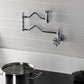Kingston Brass KS2107RX Belknap Wall Mount Pot Filler Faucet, Brushed Brass in modern kitchen setting.
