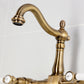 Kingston KS1263BPL Bel-Air Two-Handle Wall Mount Bridge Kitchen Faucet, Antique Brass close-up view of spout and levers