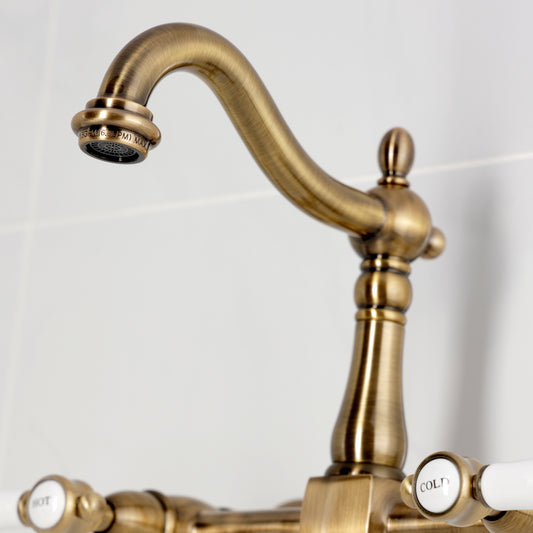 Kingston KS1263BPL Bel-Air Two-Handle Wall Mount Bridge Kitchen Faucet, Antique Brass close-up view of spout and levers