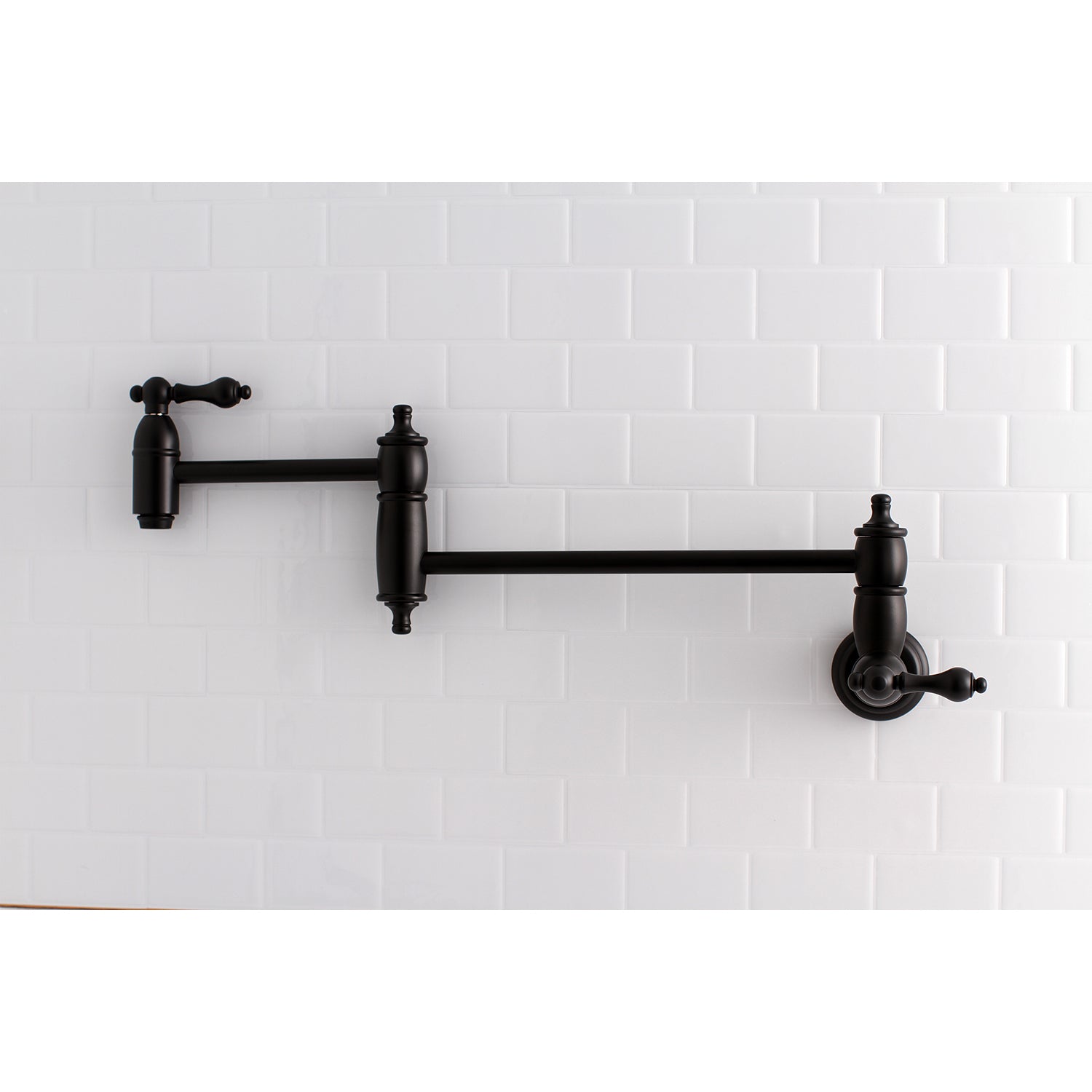 Kingston Brass KS3103AL Restoration Wall Mount Pot Filler Faucet, Antique Brass mounted on white tile background.
