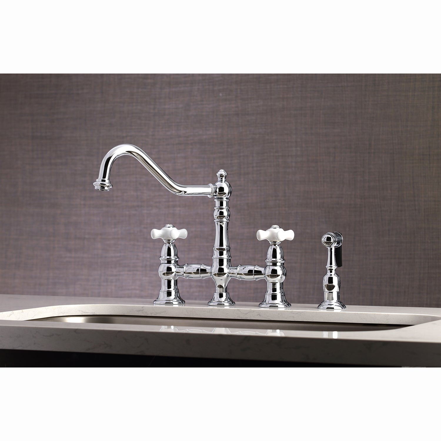 Kingston KS3277PXBS Restoration Bridge Kitchen Faucet with Brass Sprayer, Brushed Brass on a countertop.