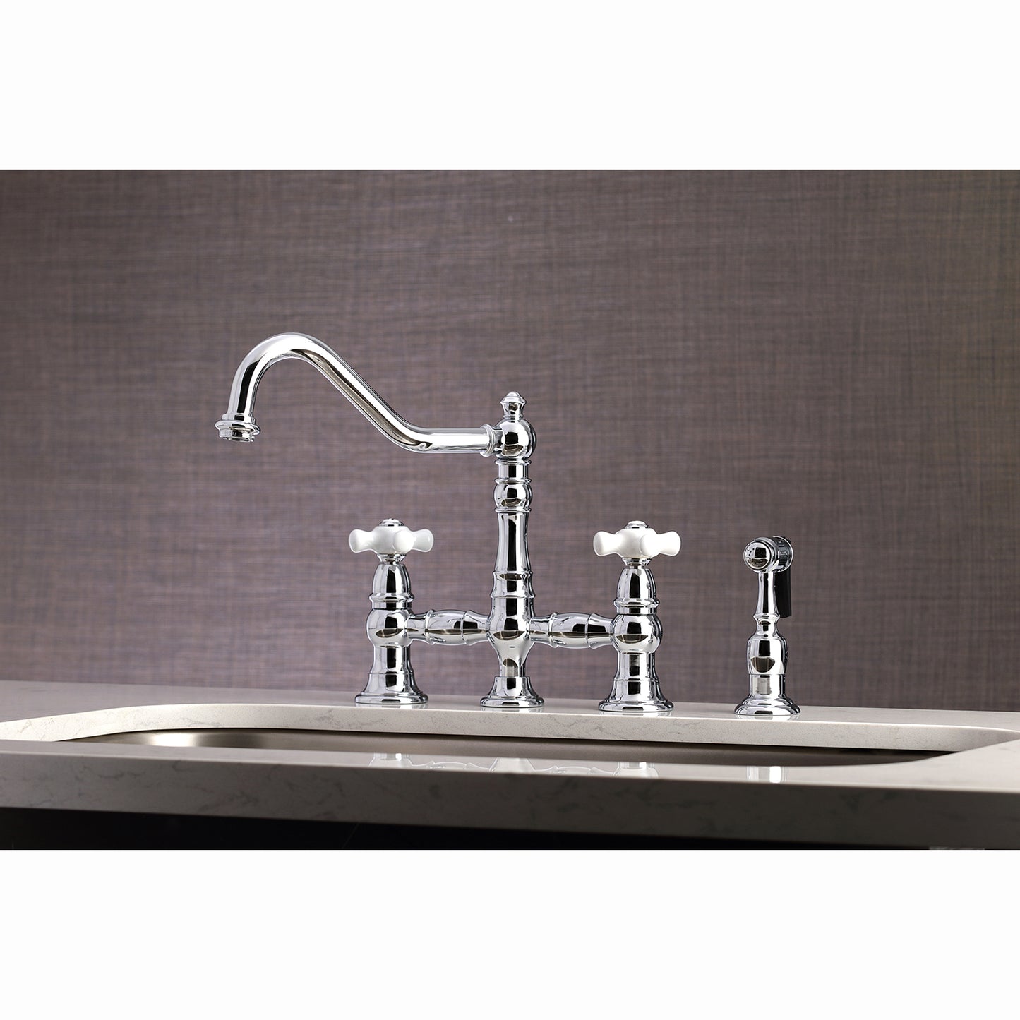 Kingston KS3277PXBS Restoration Bridge Kitchen Faucet with Brass Sprayer, Brushed Brass on a countertop.