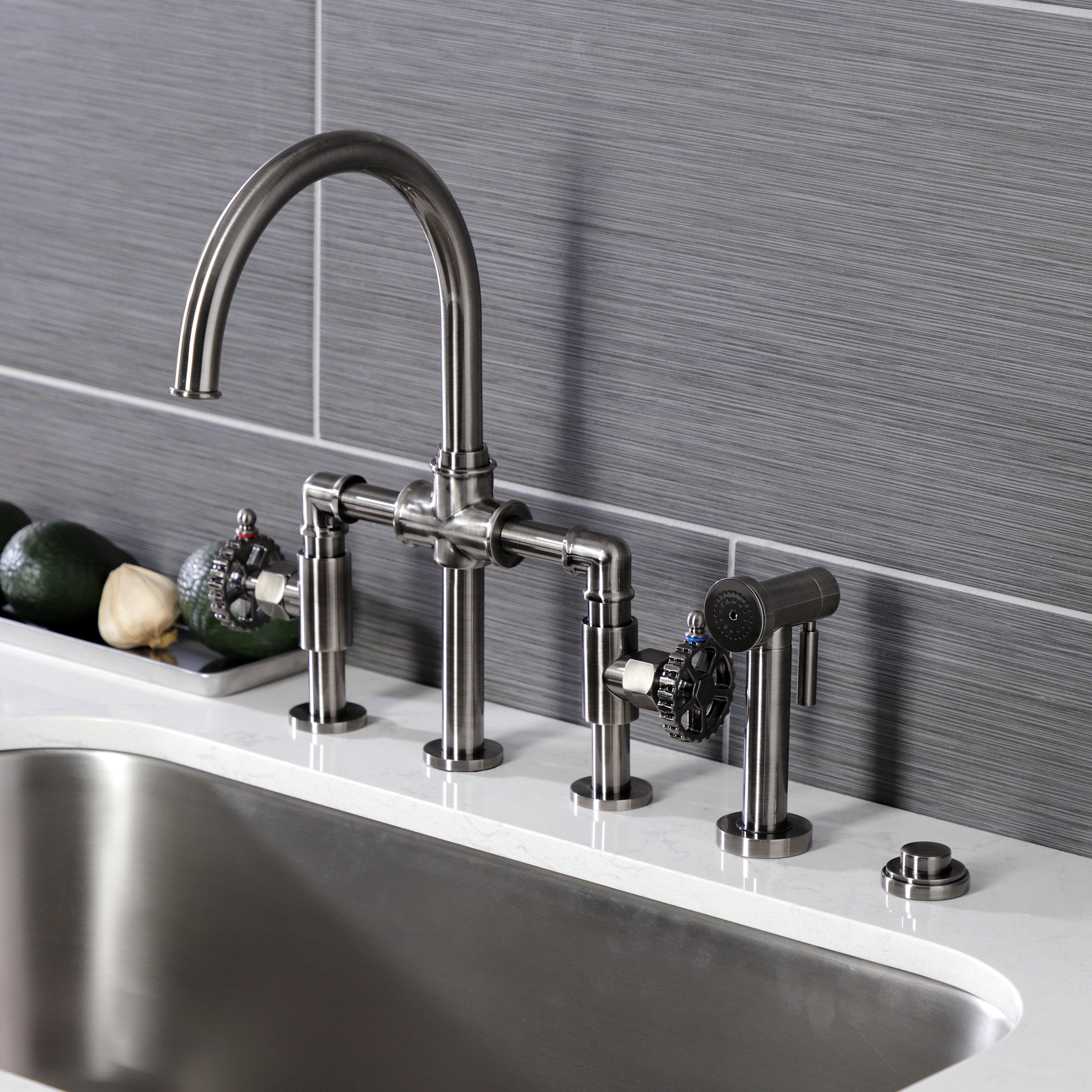 Kingston KS2334CG Fuller Industrial Style Bridge Kitchen Faucet with Brass Sprayer, Black Stainless installed in a modern kitchen.