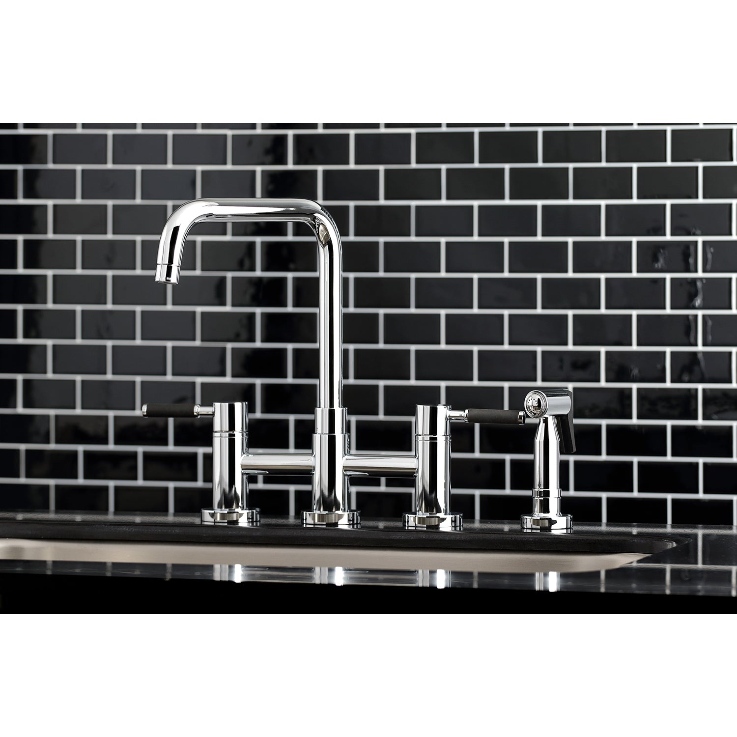 Kingston KS8287DKLBS Kaiser Bridge Kitchen Faucet with Brass Sprayer, Brushed Brass on black tiled backsplash.