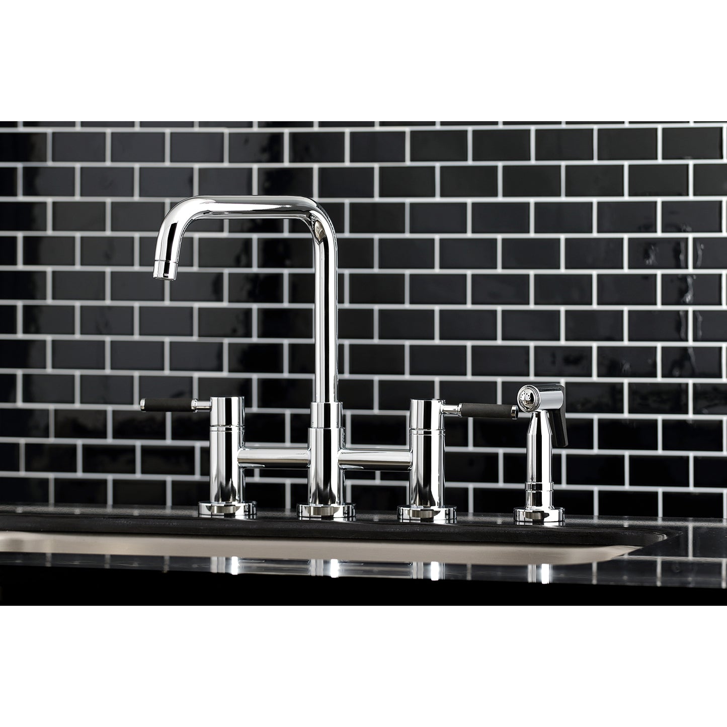 Kingston KS8287DKLBS Kaiser Bridge Kitchen Faucet with Brass Sprayer, Brushed Brass on black tiled backsplash.