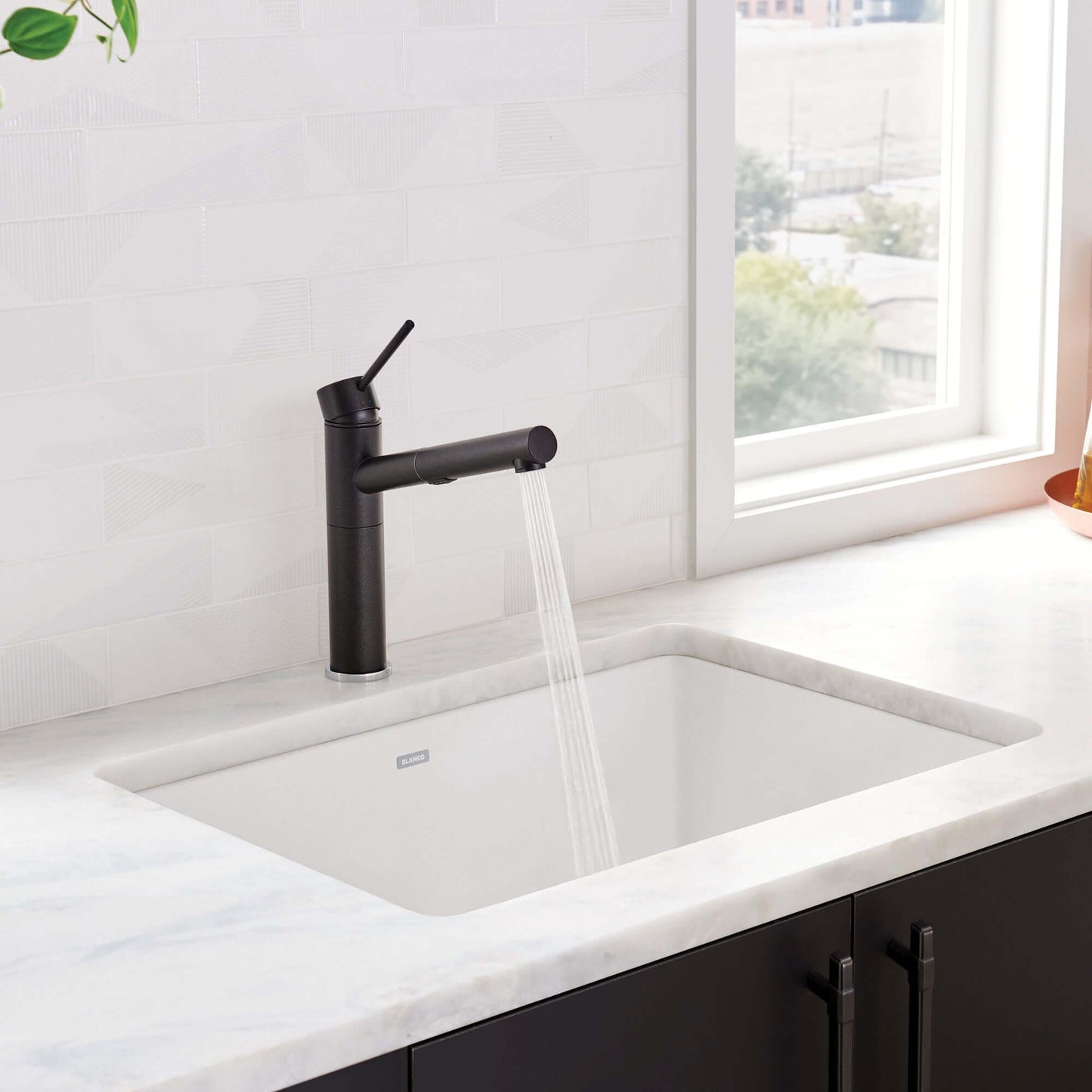 BLANCO PRECIS 27" SILGRANIT Single Bowl Undermount Sink with modern faucet and flowing water.