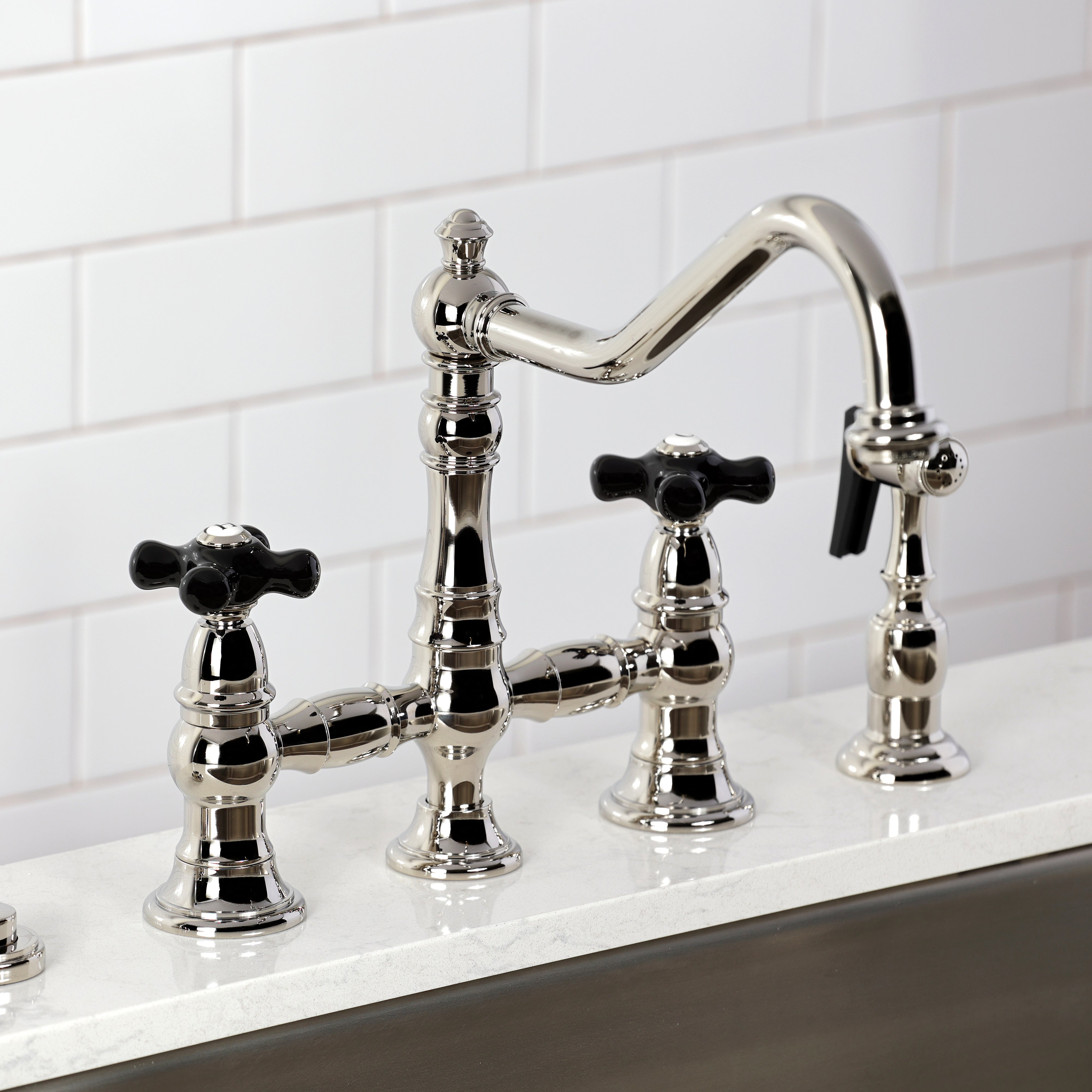 Kingston KS3277PKXBS Duchess Bridge Kitchen Faucet with Brass Sprayer, Brushed Brass on a kitchen countertop.