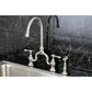 Kingston KS7793ALBS English Country Bridge Kitchen Faucet with Brass Sprayer, Antique Brass on a black marble backdrop.