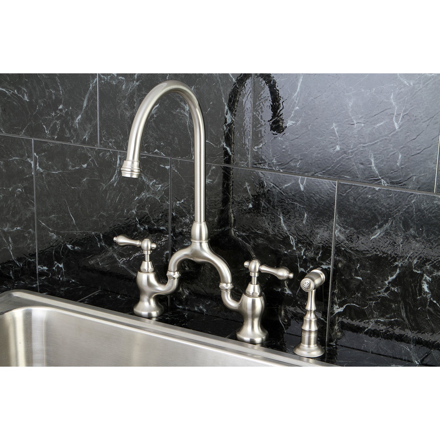 Kingston KS7793ALBS English Country Bridge Kitchen Faucet with Brass Sprayer, Antique Brass on a black marble backdrop.
