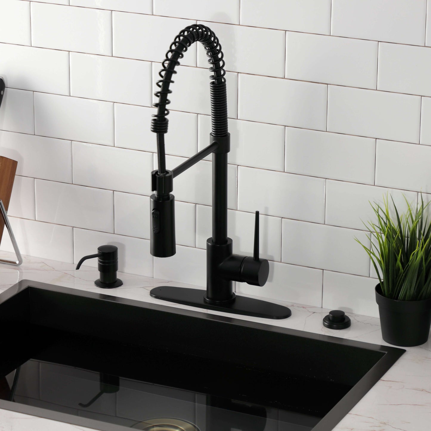 Top view of Kingston Brass LS8778NYL New York Pre-Rinse Kitchen Faucet installed in black kitchen sink.