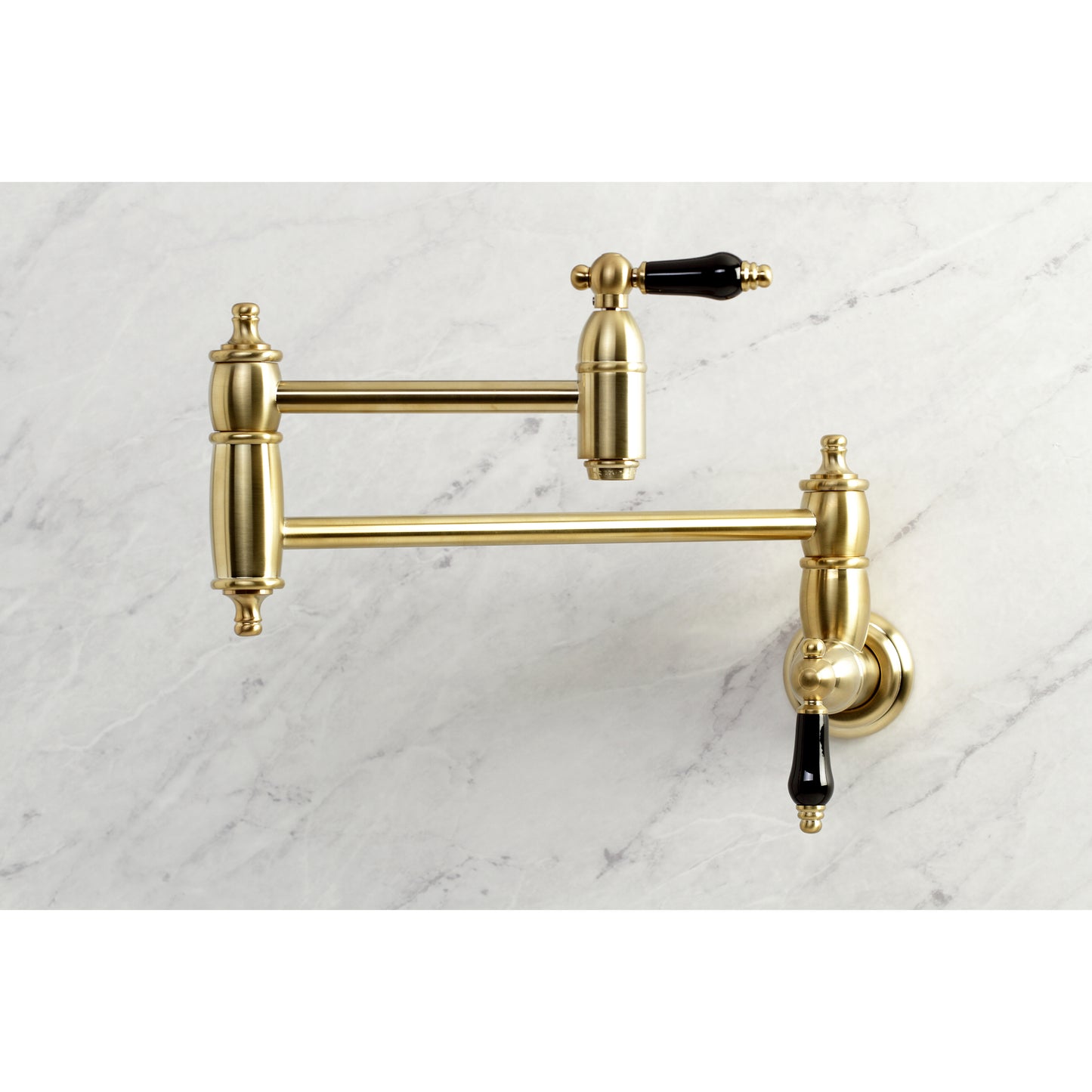 Kingston Brass KS3103PKL Duchess Wall Mount Pot Filler Faucet, Antique Brass mounted on marble background.