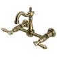 Kingston KS2443BAL Heirloom Two-Handle Wall Mount Bridge Kitchen Faucet, Antique Brass with traditional design details.