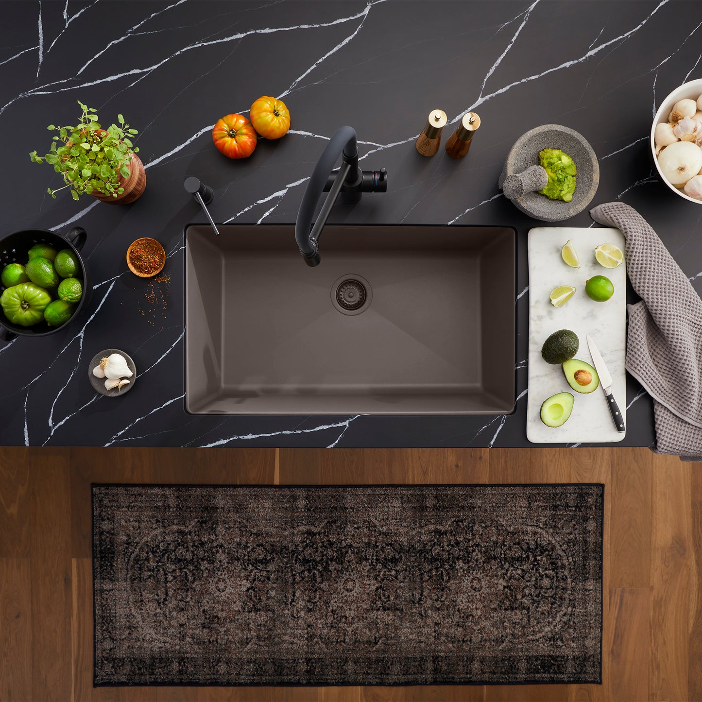 BLANCO Precis SILGRANIT 30" Single Bowl Undermount Kitchen Sink on a black marble countertop with fresh ingredients.