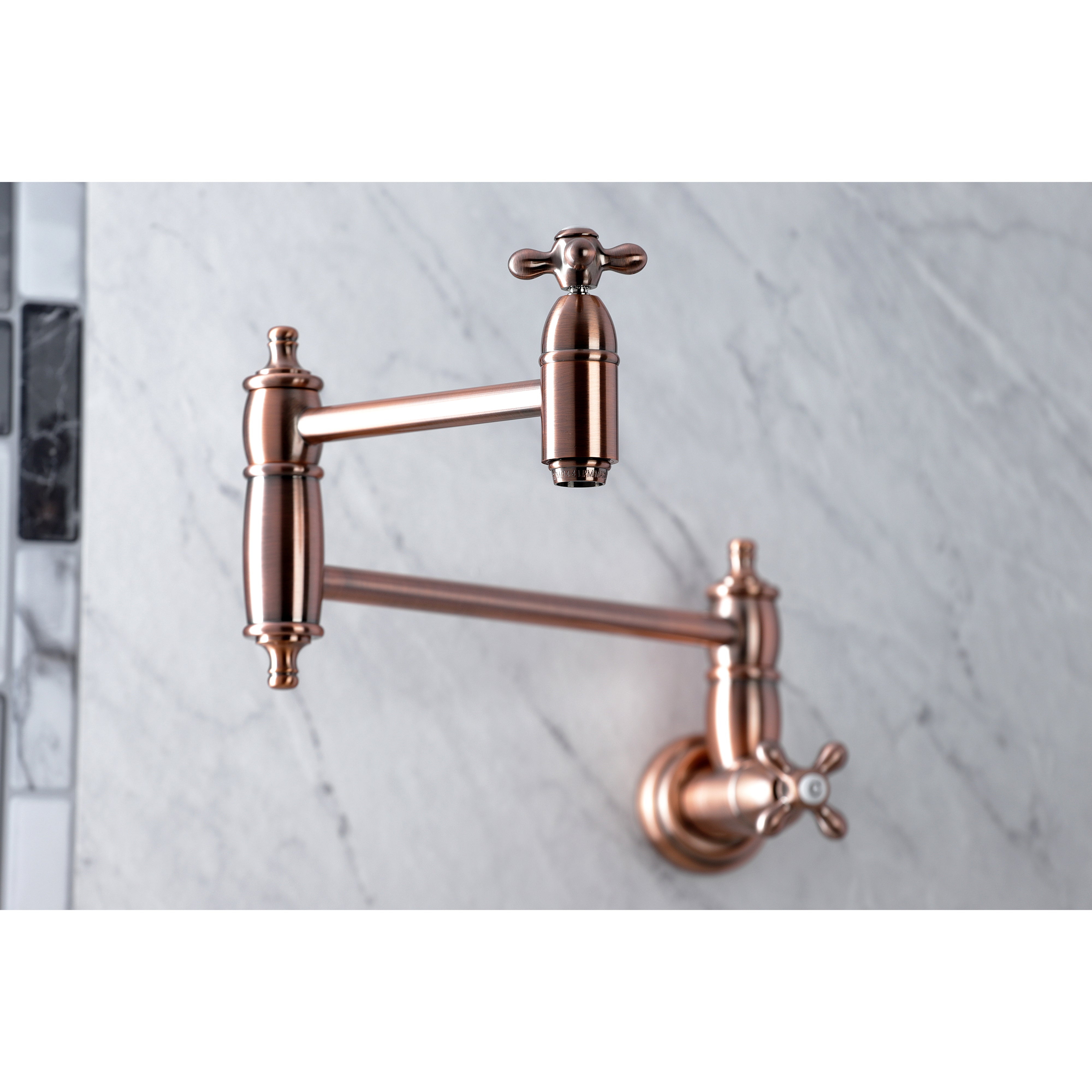 Kingston Brass KS3103AX Restoration Wall Mount Pot Filler Faucet, Antique Brass on marble background.