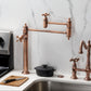 Kingston Brass KS3703AX Restoration Deck Mount Pot Filler Faucet, Antique Brass in a modern kitchen setting.