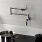 Kingston Brass KS4103KL Whitaker Wall Mount Pot Filler Faucet, Antique Brass installed in a kitchen with a pot.