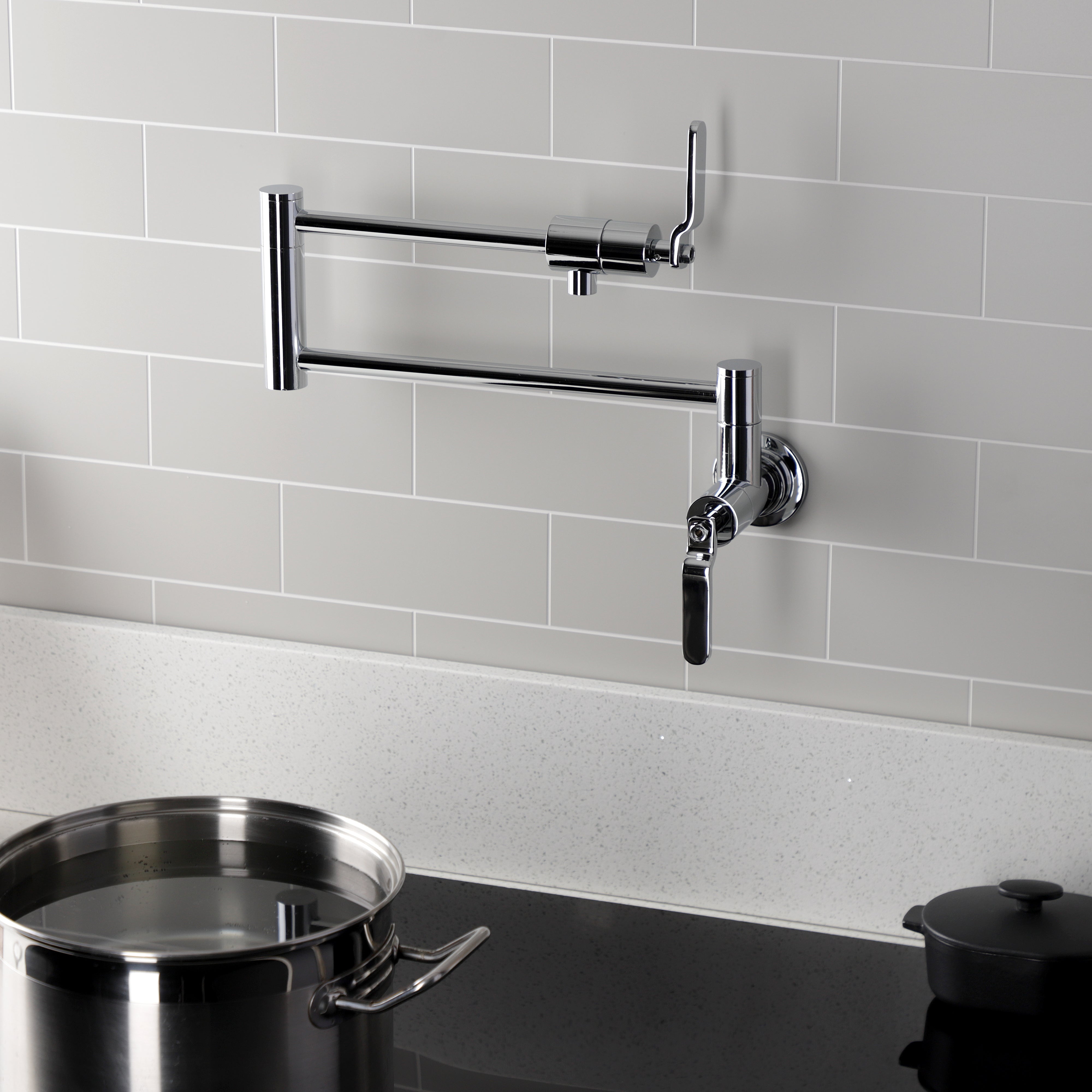 Kingston Brass KS4103KL Whitaker Wall Mount Pot Filler Faucet, Antique Brass installed in a kitchen with a pot.