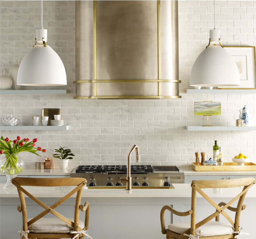 Thompson Quintana Handcrafted Oval Range Hood in Satin Brass and Burnished Nickel - KCRH48 over a modern kitchen island.